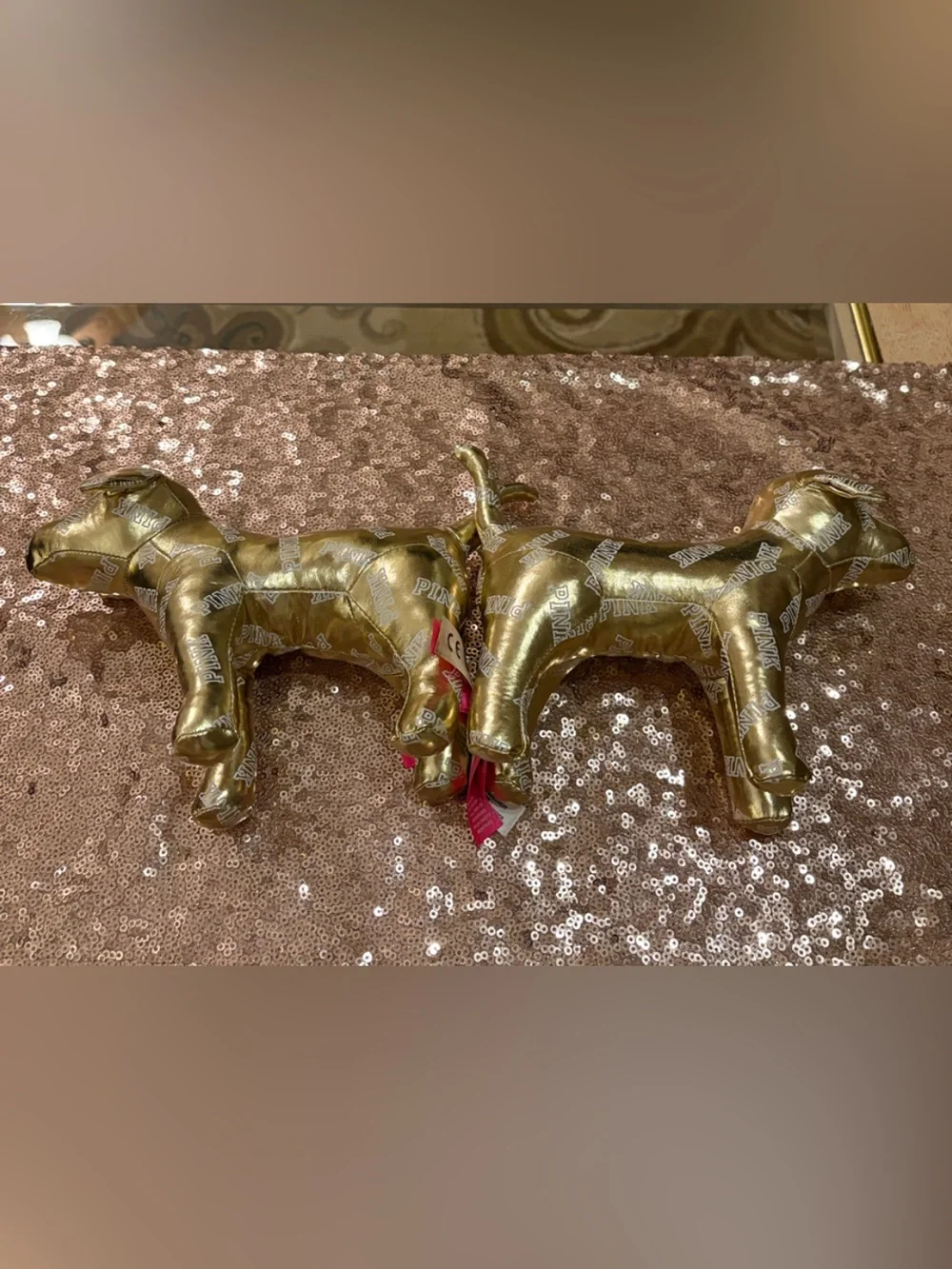 Lot of two 6” high x 10”  Victoria’s Secret gold metallic dogs w/allover logos